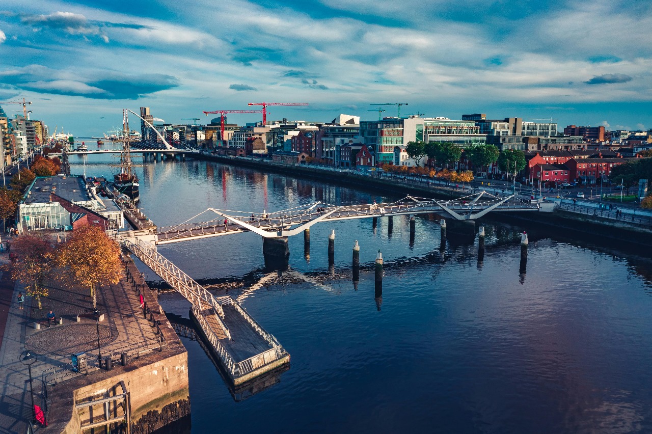 Dublin's River Liffey with modern pedestrian bridges and contemporary architecture, showcasing Ireland's blend of historic charm and modern innovation in education
