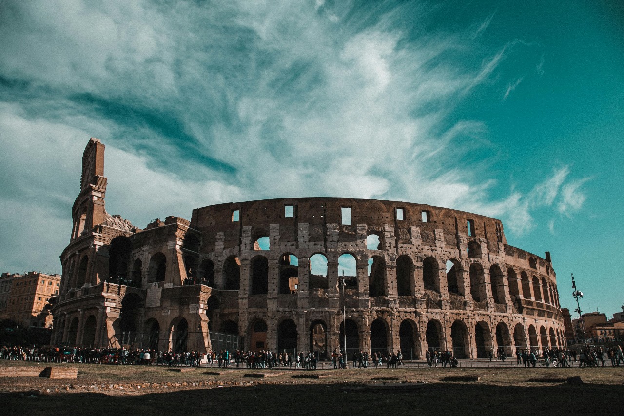 The magnificent Colosseum in Rome under dramatic sky, showcasing Italy's ancient history and excellence in arts, design, and engineering education