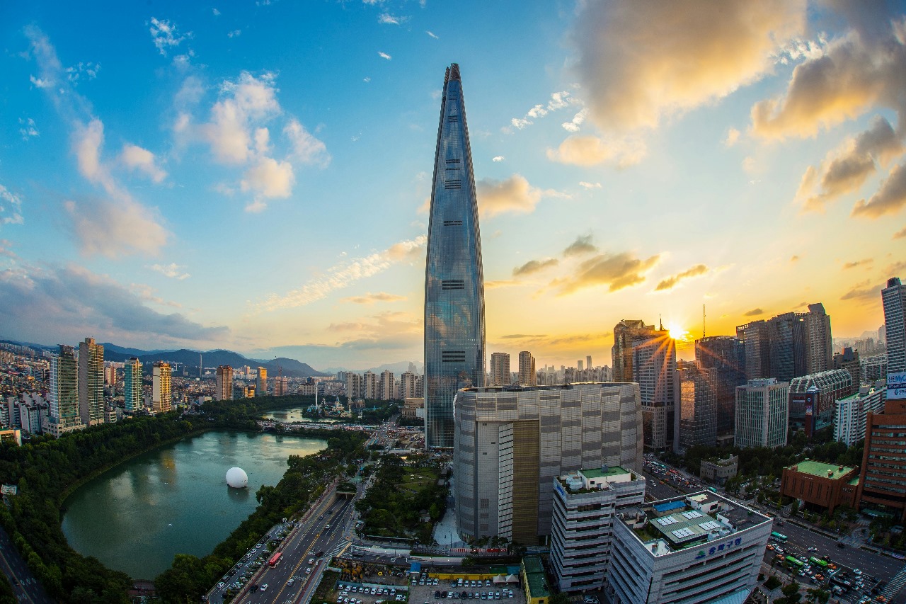 Seoul's modern skyline at sunset with Lotte World Tower and Han River, representing South Korea's technological advancement and growing education sector